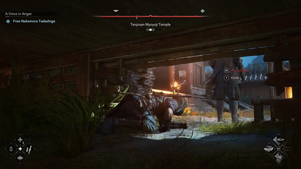 Naoe hides prone beneath temple floorboards as a patrolling guard's boots pass, the assassinate prompt waiting
